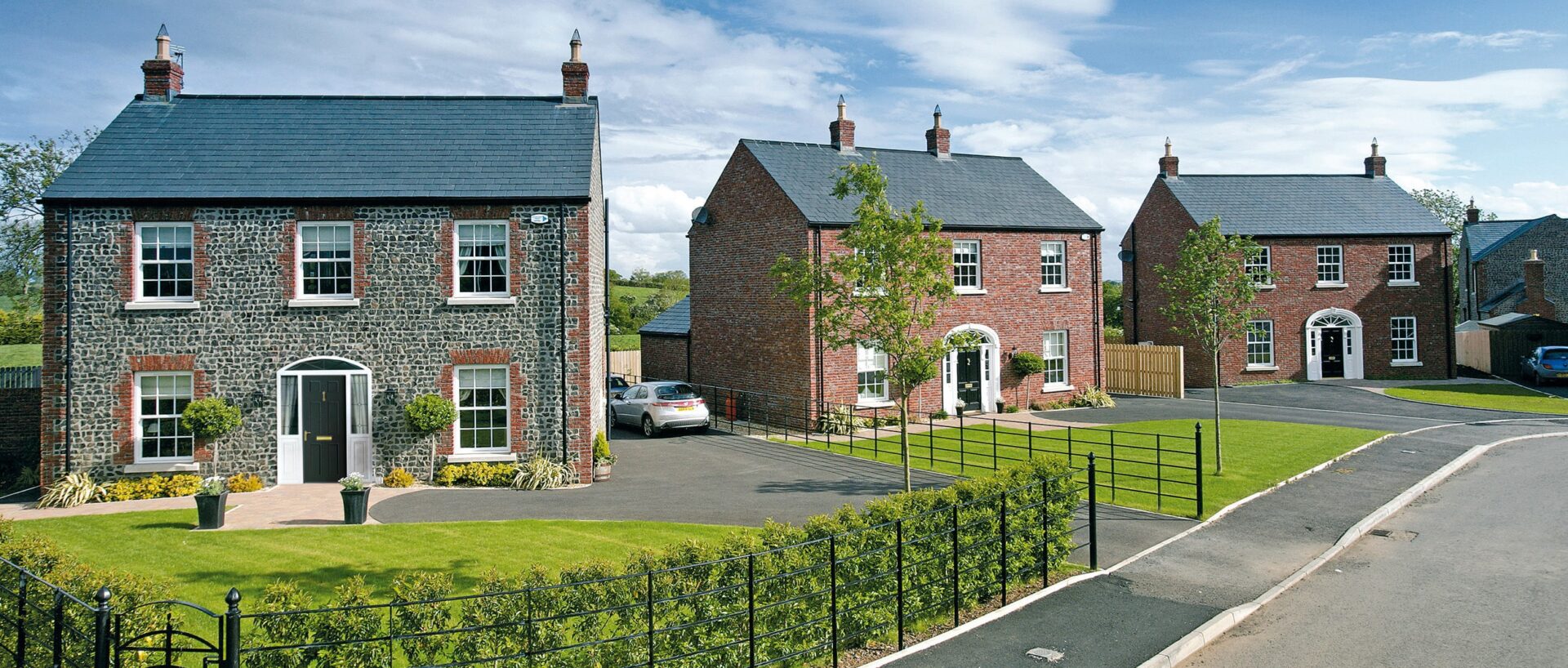 Brick houses with new white casement windows and composite front doors in Oxfordshire